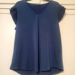 A blue short sleeve blouse with ruffles